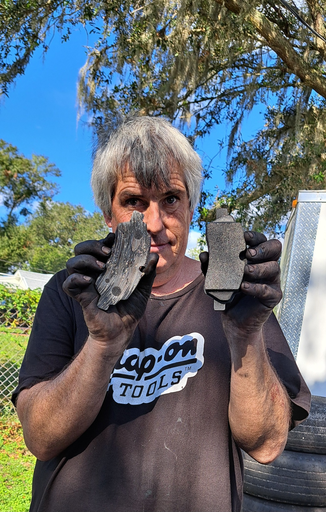 A woman holding a piece of wood in her hands